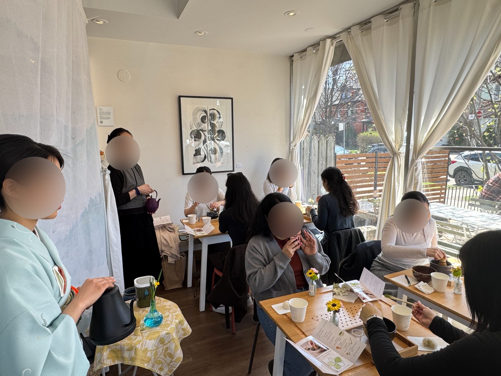Guests whisking matcha at a weekly Gleam & Sip tea ceremony at the Annex location in Toronto, led by a kimono-clad instructor