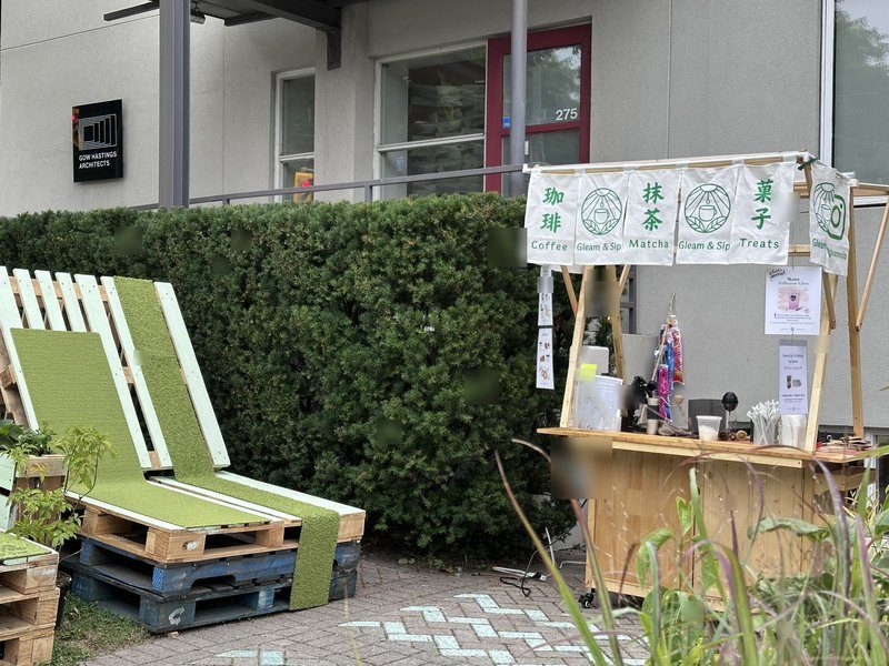 The Gleam & Sip matcha cart with Coffee, Matcha and Treats banners set up outside Gow Hastings Architects for a corporate activation in Toronto